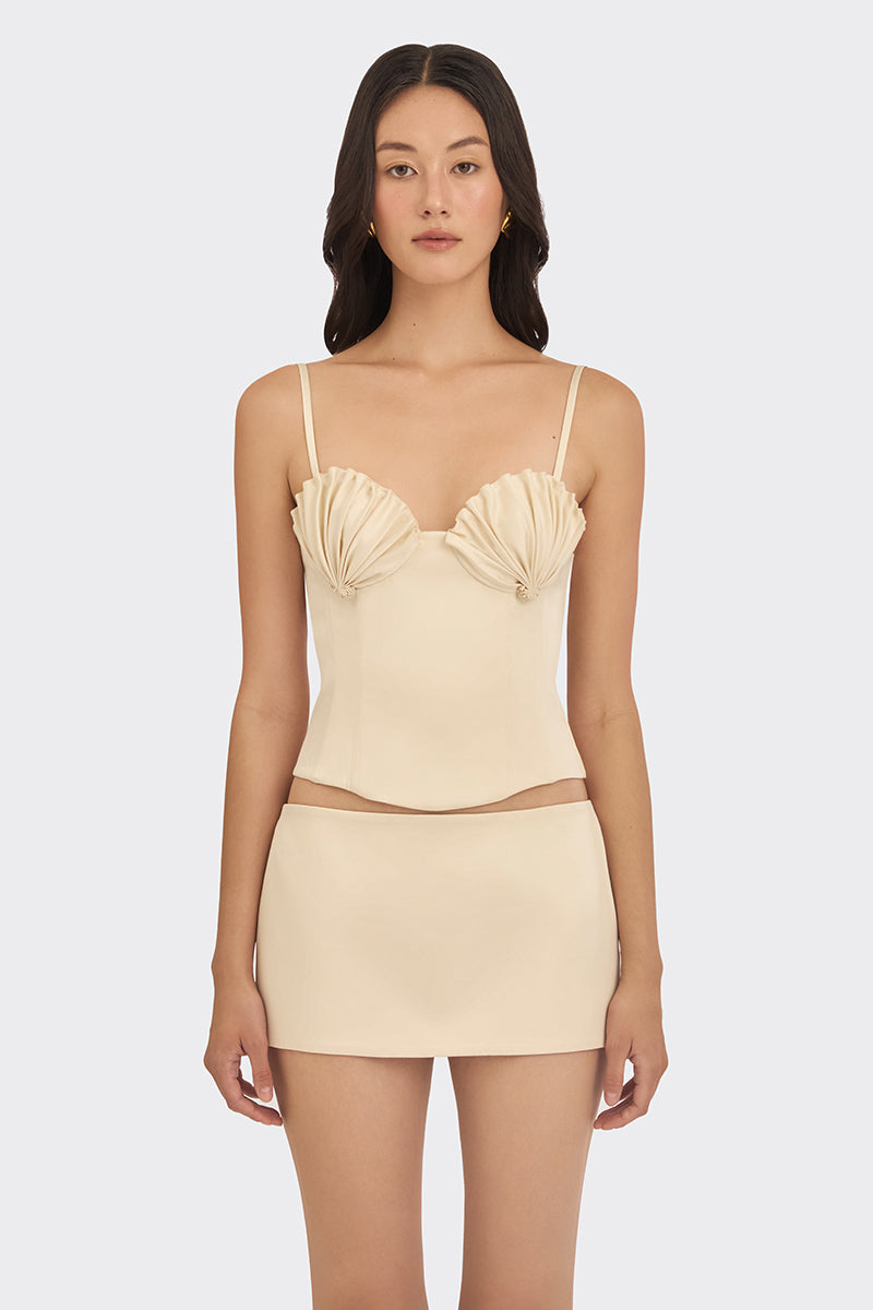 Beige shell bustier top by Stolen Stores featuring a fitted design and shell-inspired detailing on a neutral background.