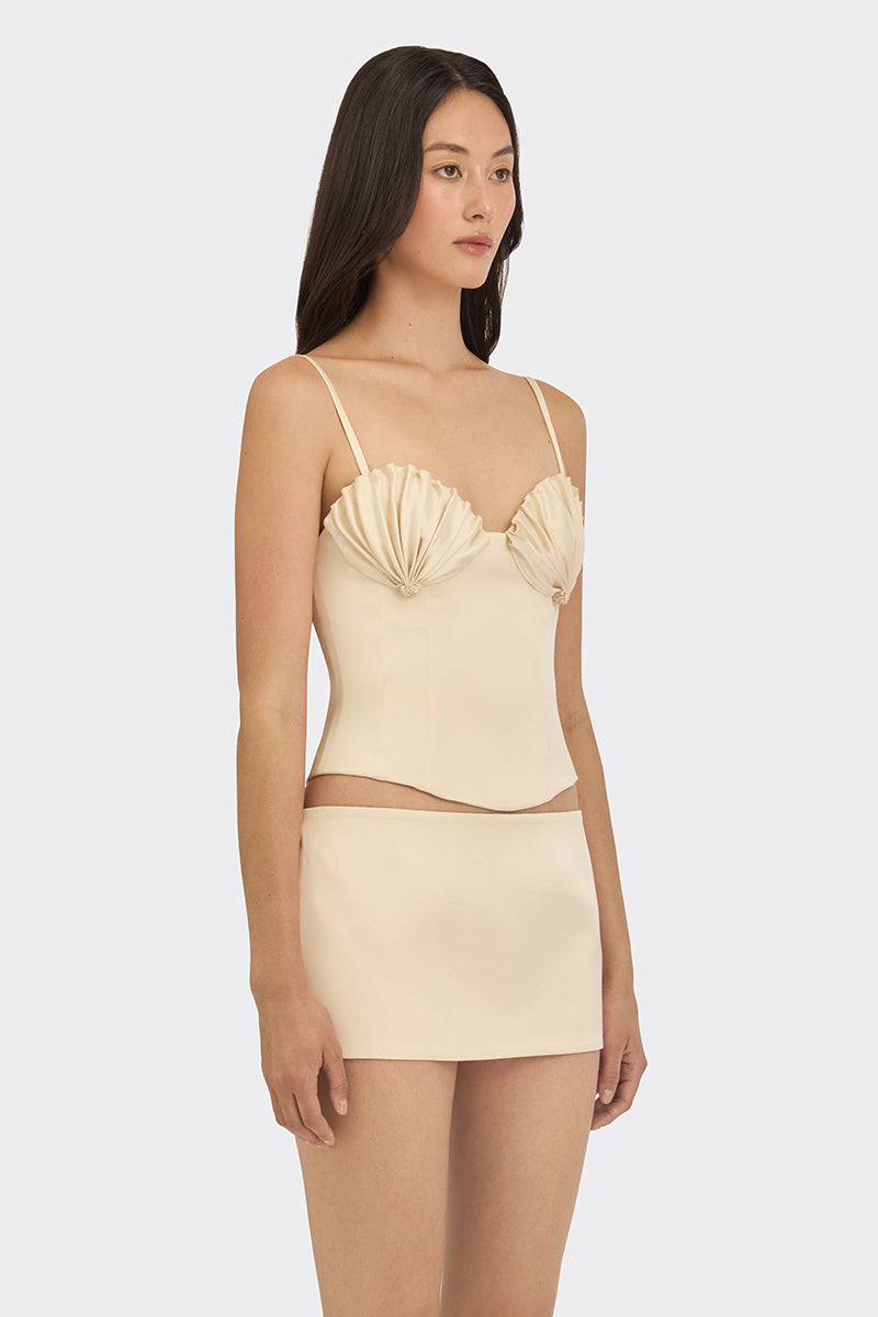 Beige shell bustier top by Stolen Stores, featuring structured design and shell embellishments, perfect for stylish outfits.