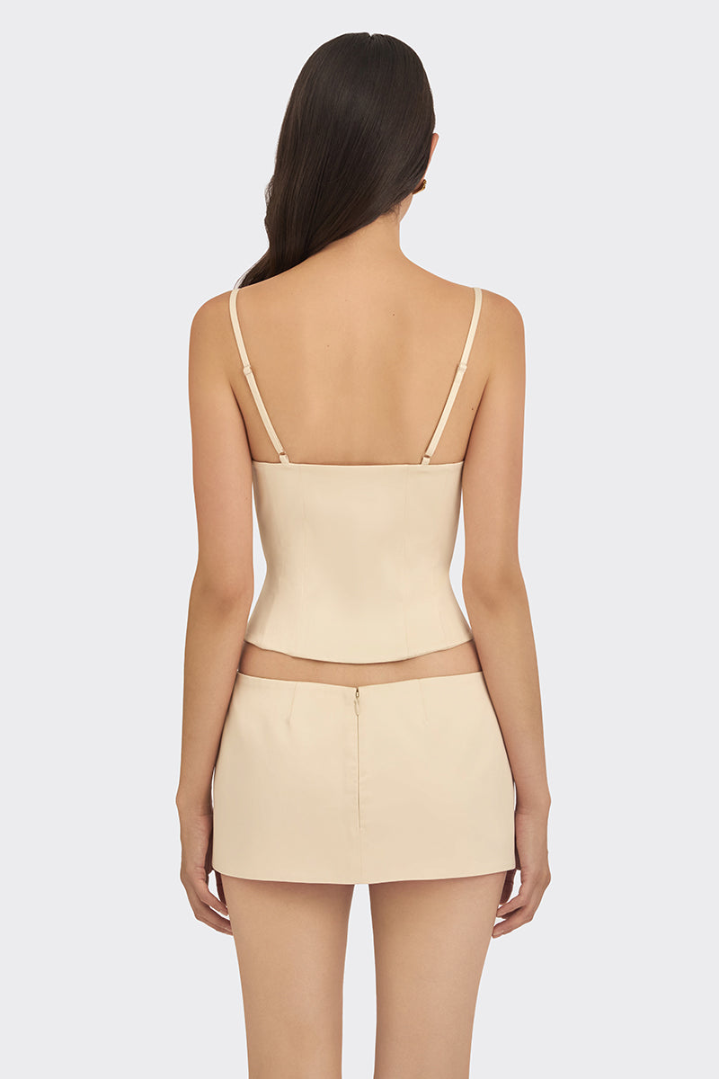 Beige shell bustier top by Stolen Stores, featuring a fitted design with shell embellishments and adjustable straps.