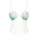 Off-white shell hand-embroidered bustier top by Stolen Stores, featuring intricate embroidery and fitted design.