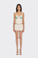 Off-white embroidered shell hand-embellished bustier top by Stolen Stores, showcasing intricate embroidery and fitted design.