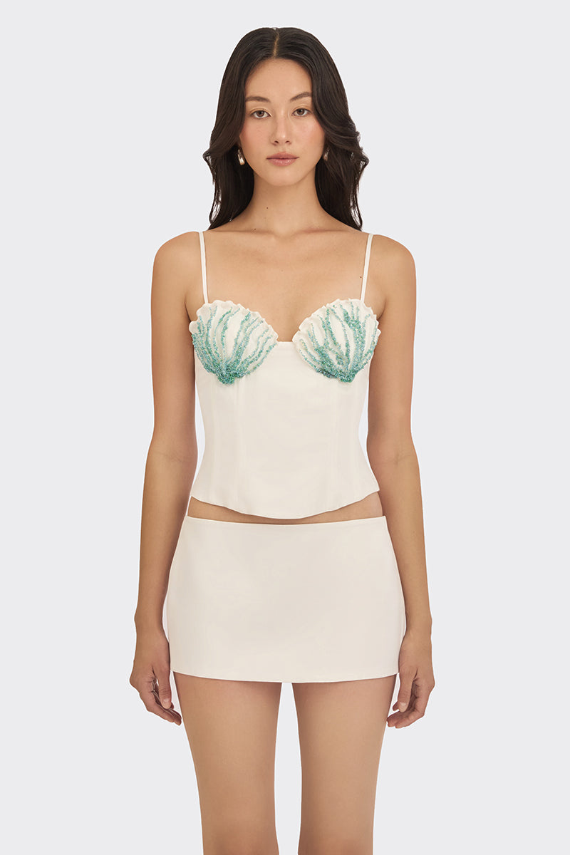 Off-white shell hand-embroidered bustier top by Stolen Stores, featuring intricate embroidery and a fitted design.