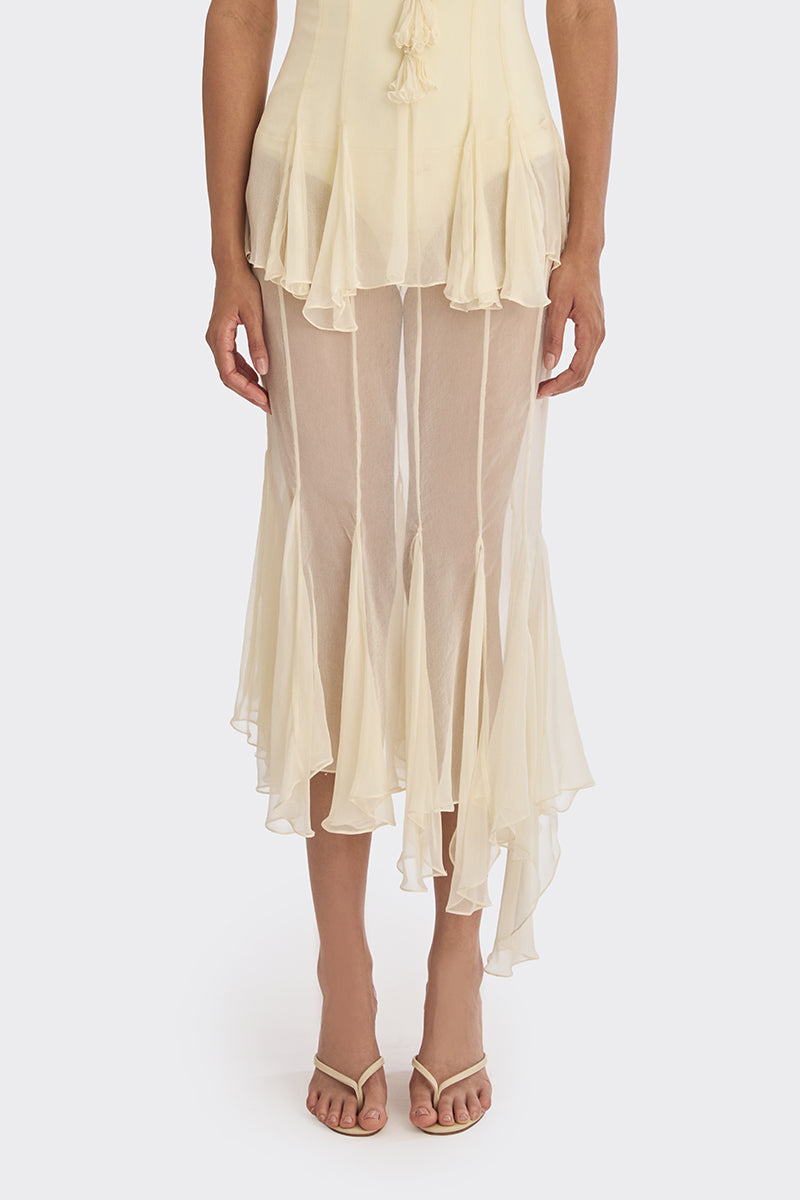 Light yellow asymmetric sheer maxi skirt by Stolen Stores featuring a shell motif and flowing, elegant design.
