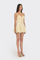 Light yellow shell corset mini dress by Stolen Stores, featuring a fitted silhouette and stylish shell-inspired design.