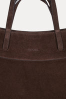 Saonara chocolate suede shoulder bag with sleek design and adjustable strap, showcasing its soft textured material and elegant shape.