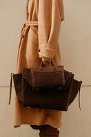 Saonara chocolate suede shoulder shopping bag with sleek design and sturdy handles, perfect for everyday use.