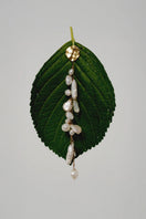 LAVANI JEWELS Siena Pearl Earrings featuring elegant pearl drops and gold-tone hooks on a neutral background