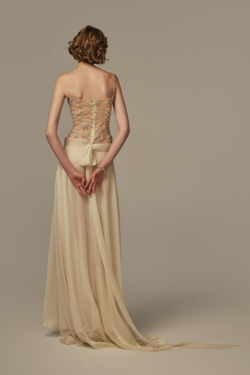 Pastel yellow POEM Sieste maxi dress displayed on a model, showcasing a flowing, elegant design perfect for summer wear.
