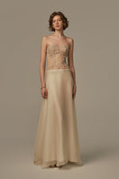 Pastel yellow POEM Sieste gown displayed on a model, featuring soft fabric and elegant design for comfortable wear.
