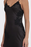 Black V-neck lace maxi dress by Stolen Stores, featuring a flowing silhouette and elegant neckline for stylish occasions.