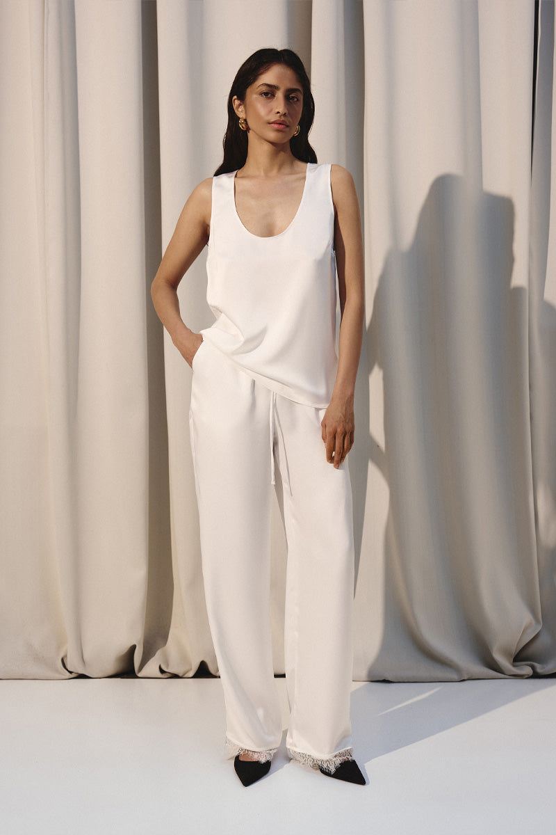 Ivory silky lounge pants with delicate lace trim by Kris Marán, featuring a comfortable relaxed fit and elegant details.