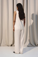 Ivory silk lounge pants with delicate lace trim by Kris Marán, featuring a relaxed fit and elegant design.