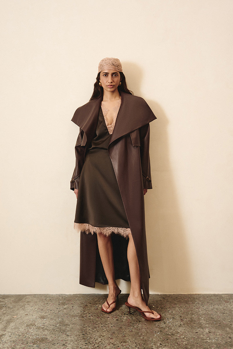 Brown silk midi skirt with lace detailing by Kris Marán, featuring a smooth fabric and elegant design.