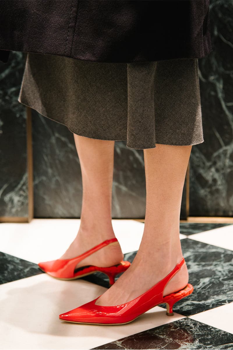 A pair of AERA Silvana red patent-effect slingback pumps with pointed toes and stiletto heels, displayed on a neutral background.