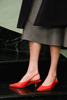 A pair of AERA Silvana red patent-effect slingback pumps with pointed toes and sleek heel, displayed on a white background.