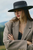 Silver gray canotier hat by LE SH KA featuring a stylish woven design and a wide brim for a chic, summery look.
