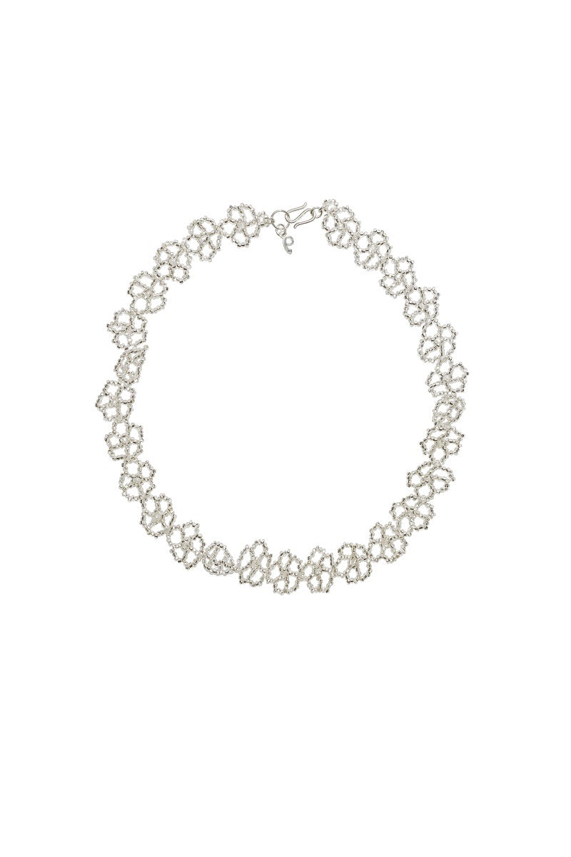 Silver Flower Feast necklace by Pura Utz featuring a delicate floral pendant on a silver chain.