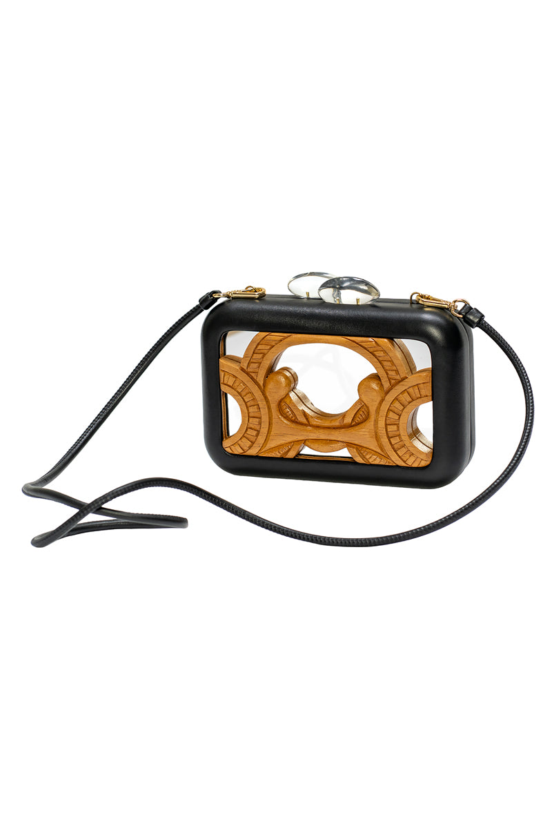 Black Sy&Vie Simetrís Curves Mirror clutch bag with sleek curved design, featuring a glossy finish and compact size.