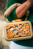 Beige acrylic clutch with a honeycomb pattern from Sy&Vie, featuring a sleek, modern design perfect for stylish accessories.