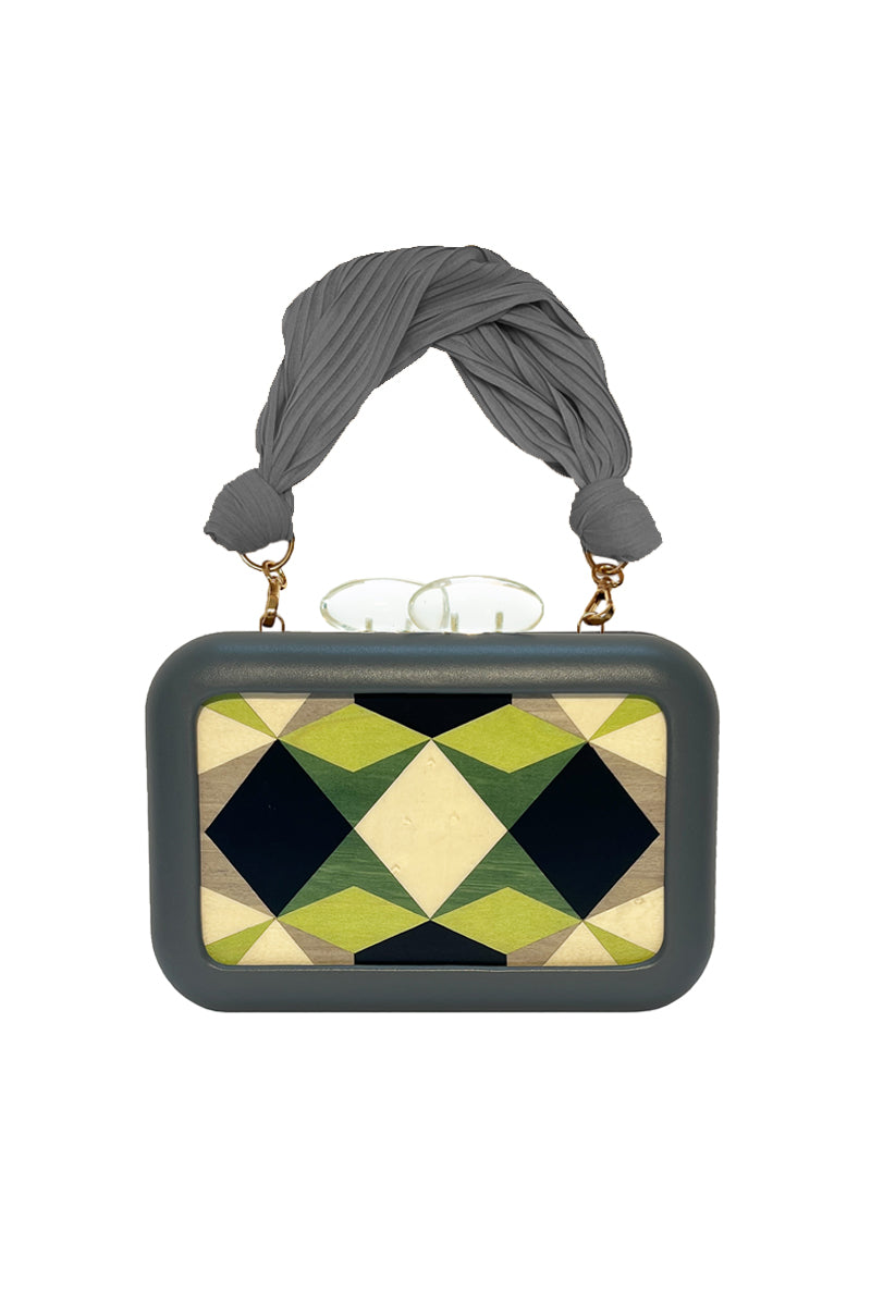 Green Sy&Vie Simetrís Polygons clutch with geometric polygon design, featuring a sleek, modern style and compact size.
