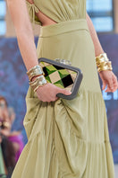 Green Sy&Vie clutch with geometric polygon design, featuring a sleek rectangular shape and modern style.