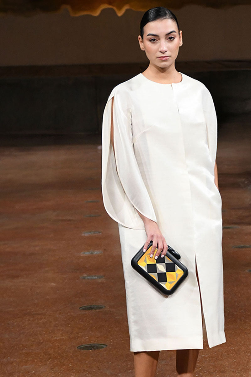 Yellow Sy&Vie clutch with geometric polygon design, featuring a sleek rectangular shape and modern style.
