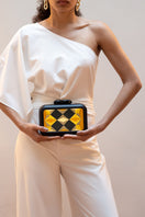 Yellow geometric clutch bag from Sy&Vie featuring polygon patterns and a sleek, modern design.