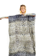 Skin Brocot kaftan maxi dress by Amel Batita, featuring flowing fabric and intricate brocot details, shown with matching gloves.