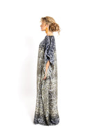 Amel Batita skin brocot kaftan maxi dress displayed on a model, showcasing its flowing fabric and elegant design.