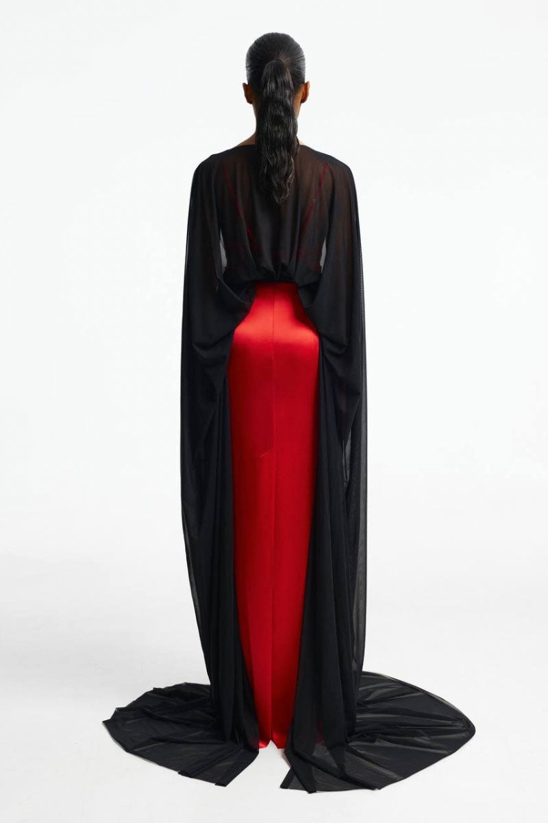 Red pleated maxi skirt by Santa Brands featuring flowing fabric and a high-waisted design.
