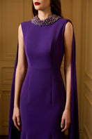 Sleeveless TIANA crepe cape gown with a mermaid silhouette and long back train by I.H.F, displayed on a model.