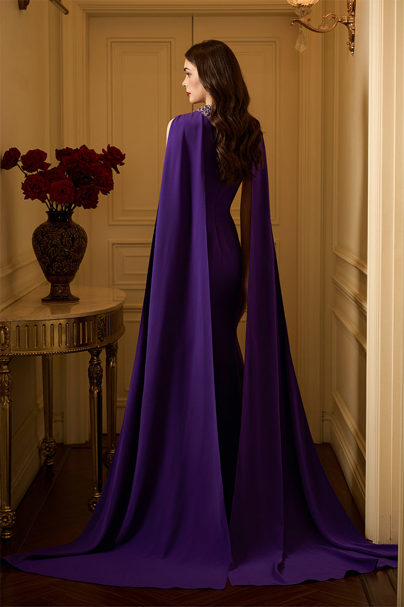 Elegant sleeveless TIANA crepe cape gown by I.H.F featuring a mermaid silhouette and a long back train.