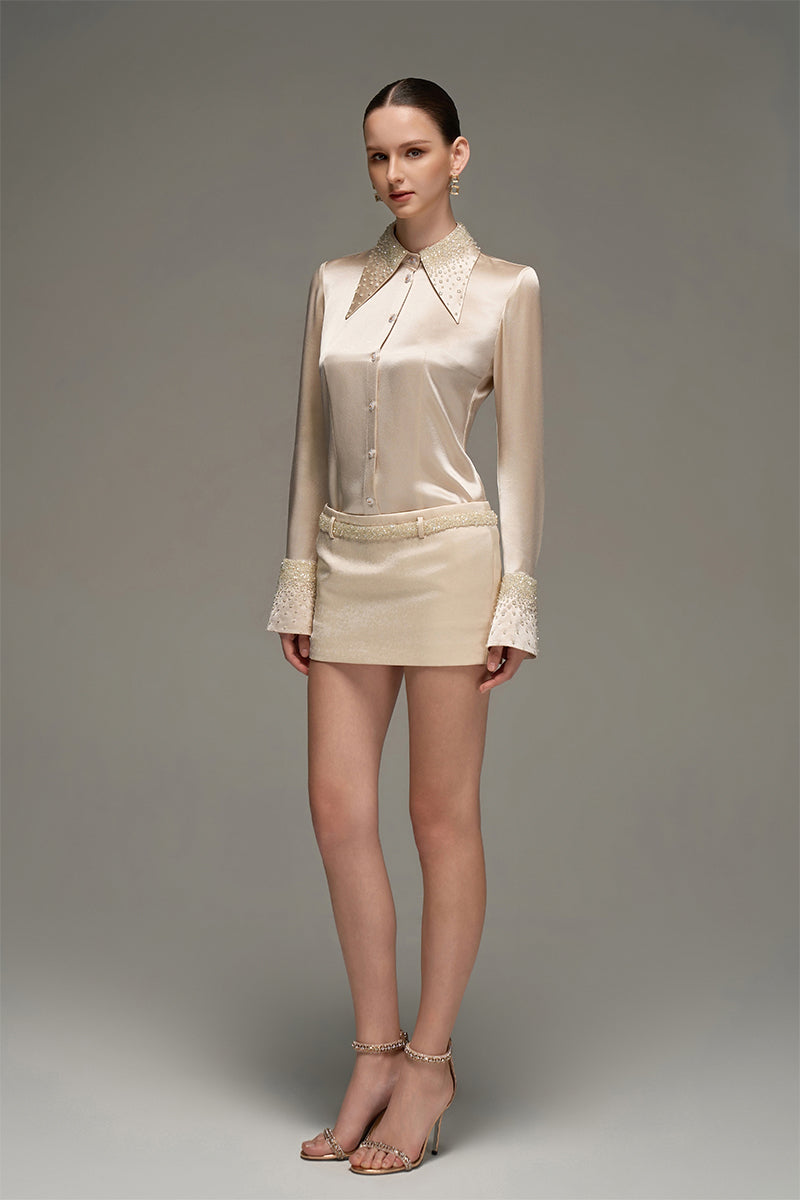 Beige satin shirt and skirt co-ords set by I.H.F Studio, slim-fit shirt with statement cuffs visible in the image.