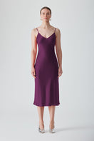 Aubergine MASTANI slip dress in midi length, featuring smooth fabric and a sleek, elegant design, displayed on a hanger.