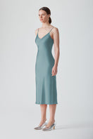 Light blue MASTANI slip dress in Saxon fabric, midi length, with a sleek, minimalist design and smooth fabric appearance.