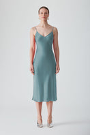 Light blue MASTANI slip dress in Saxon fabric, midi length, sleeveless design, smooth fabric with subtle drape, elegant and versatile style.