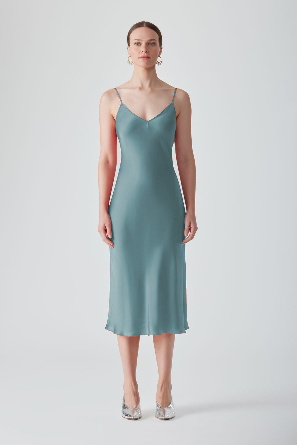 Light blue MASTANI slip dress in Saxon fabric, midi length, sleeveless design, smooth fabric with subtle drape, elegant and versatile style.