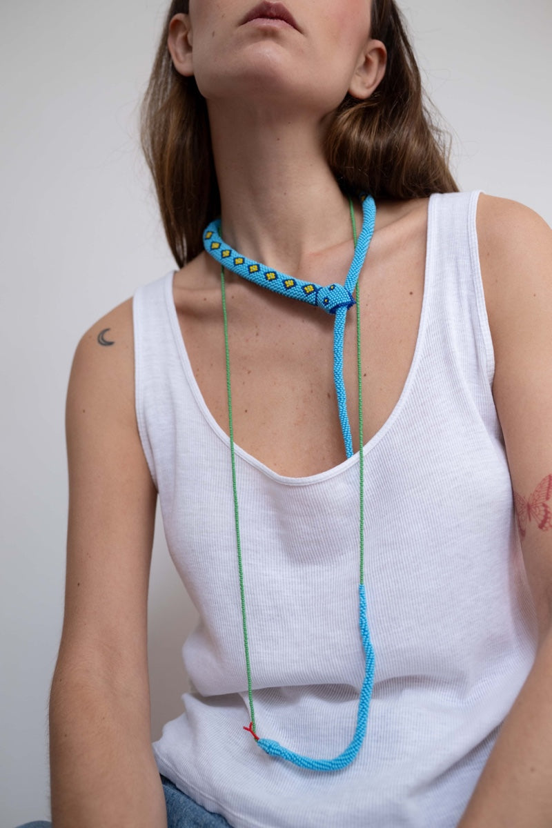 Light blue snake totem necklace by Pájara Pinta featuring a detailed guardian snake design on a sleek chain.