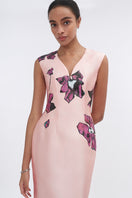 Soft pink orchid V-neck mermaid maxi dress by Tiny Ink, featuring a fitted bodice and flowing skirt, perfect for elegant occasions.