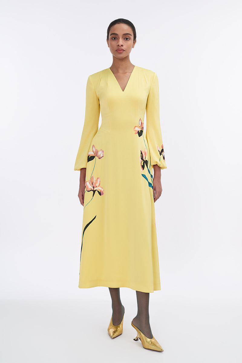 Soft yellow bishop sleeve flared midi dress by Tiny Ink, showcasing a flowy silhouette and elegant design.