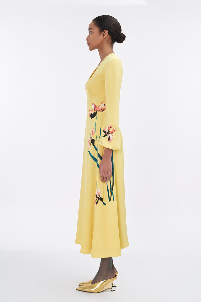 Soft yellow bishop sleeve flared midi dress by Tiny Ink, featuring flowy fabric and a relaxed fit perfect for casual occasions.