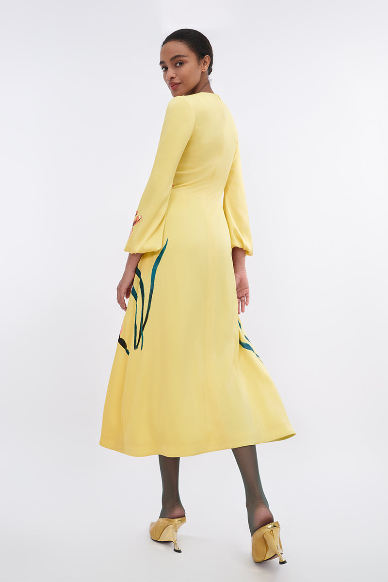 Soft yellow bishop sleeve flared midi dress by Tiny Ink, featuring a relaxed fit and elegant design, shown on a model.