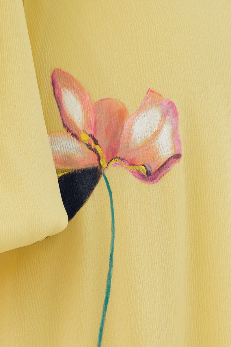 Soft yellow bishop sleeve flared midi dress by Tiny Ink, featuring flowy fabric and elegant design, shown on a model.