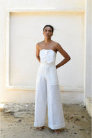 Off-white ANA + MARIA SOLE PANTS displayed on a hanger, showcasing a stylish, high-quality pair of pants with a modern design.