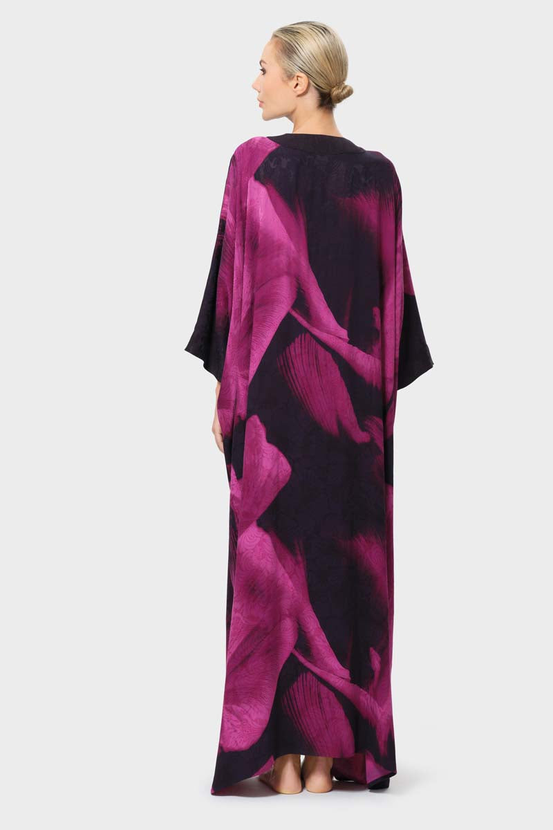 niLuu Sophia Kaftan robe with flowing fabric and intricate patterns, shown from the back on a model.