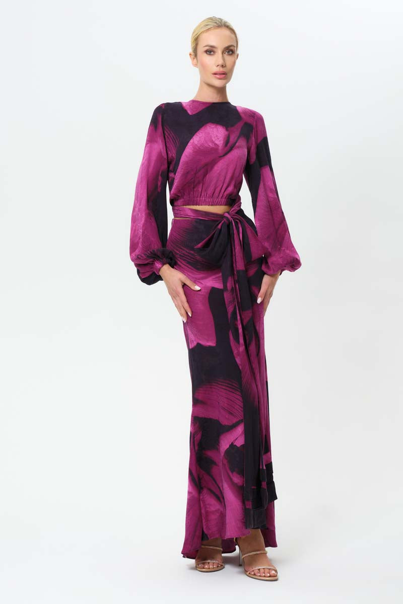 Long navy blue maxi slip skirt by niLuu, featuring a smooth, flowing fabric and a relaxed fit, styled with a wrap top.