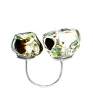 Salvarea Soplo double ring in green, featuring a modern design with intertwined bands, worn on a finger.