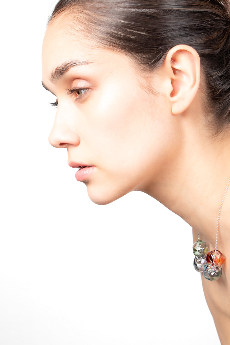 Multicolor SOPLO necklace by SALVÁREA featuring multiple layered chains and vibrant beads for a bold, stylish look.