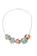 Colorful multi-strand SALVÁREA SOPLO necklace featuring layered, vibrant beads and intricate design on a neutral background.