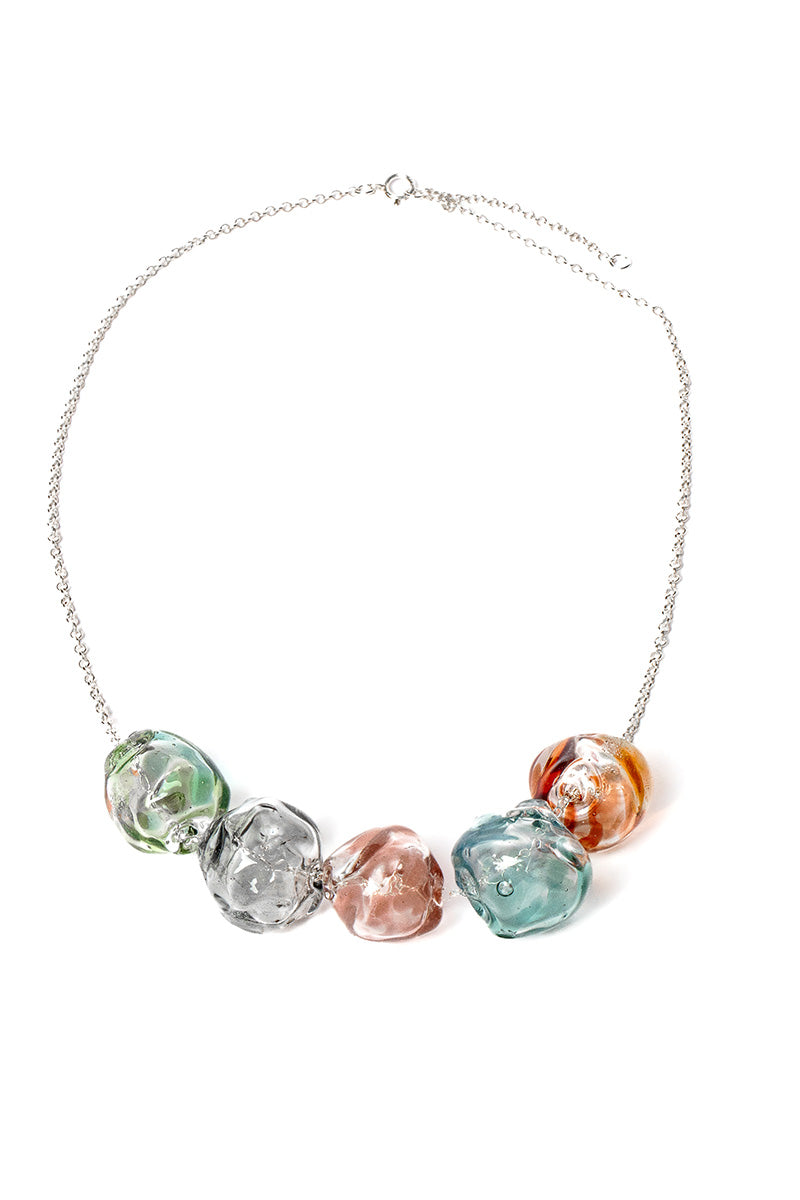 Colorful multi-strand SALVÁREA SOPLO necklace featuring layered, vibrant beads and intricate design on a neutral background.